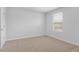 Bedroom boasts neutral walls and carpet with a large window bringing in natural light at 288 Overlook Rd, Covington, GA 30014