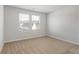 Neutral bedroom with two windows bringing in natural light and plush carpeting at 288 Overlook Rd, Covington, GA 30014