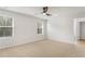 Well-lit bedroom features plush carpet, ceiling fan, and windows with wooded views at 288 Overlook Rd, Covington, GA 30014