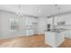 Open-concept kitchen with a center island, stainless steel appliances, and modern white cabinetry at 288 Overlook Rd, Covington, GA 30014