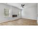 Cozy living room features an electric fireplace, hardwood floors, and plenty of natural light from the windows at 288 Overlook Rd, Covington, GA 30014