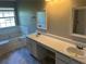 Bathroom features dual sinks with a large vanity and a tiled tub at 5719 Star Flower Dr, Ellenwood, GA 30294