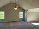 Spacious carpeted bedroom with vaulted ceiling, ceiling fan, and sunlit windows at 5719 Star Flower Dr, Ellenwood, GA 30294