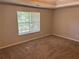 Carpeted bedroom with a large window that floods the space with natural light at 5719 Star Flower Dr, Ellenwood, GA 30294