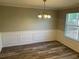 Cozy dining room featuring gray walls, white trim, and a stylish chandelier at 5719 Star Flower Dr, Ellenwood, GA 30294