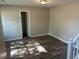 Bright room with hardwood floors and an open doorway with white trim at 5719 Star Flower Dr, Ellenwood, GA 30294