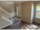 Inviting foyer featuring fresh gray walls, decorative trim, and wood-look flooring at 5719 Star Flower Dr, Ellenwood, GA 30294