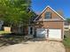 Charming two-story brick home with a two-car garage and well-maintained front yard at 5719 Star Flower Dr, Ellenwood, GA 30294