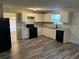 Well-lit kitchen featuring granite countertops, white cabinets, and modern appliances at 5719 Star Flower Dr, Ellenwood, GA 30294