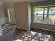 Inviting foyer featuring fresh gray walls, decorative trim, and wood-look flooring at 5719 Star Flower Dr, Ellenwood, GA 30294