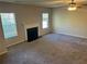 Spacious living room with plush carpet, a cozy fireplace, and a ceiling fan at 5719 Star Flower Dr, Ellenwood, GA 30294