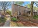 A view of the exterior of the brick townhouse with a screened in porch and outdoor patio at 6700 Roswell Rd # 20D, Sandy Springs, GA 30328