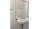 Bathroom featuring a white pedestal sink, framed mirror, and modern fixtures at 6700 Roswell Rd # 20D, Sandy Springs, GA 30328