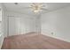 Bedroom featuring neutral carpet, ample closet space, and bright lighting at 6700 Roswell Rd # 20D, Sandy Springs, GA 30328