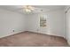 A bright bedroom with carpet, a ceiling fan, and a window at 6700 Roswell Rd # 20D, Sandy Springs, GA 30328