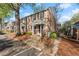 Charming brick townhome featuring a covered entryway and well-maintained landscaping at 6700 Roswell Rd # 20D, Sandy Springs, GA 30328