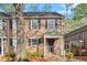 Townhouse featuring a brick facade, black shutters and a covered porch at 6700 Roswell Rd # 20D, Sandy Springs, GA 30328