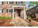 Covered brick porch with white columns, steps and a black metal railing at 6700 Roswell Rd # 20D, Sandy Springs, GA 30328