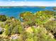 Expansive aerial shot showcasing waterfront properties nestled among lush trees on a scenic lake at 1762 Green Rd, Buford, GA 30518