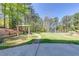 The backyard features a manicured lawn, mature trees, and a built-in playground at 1762 Green Rd, Buford, GA 30518