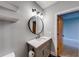 This bathroom features floating shelves, a round mirror and modern vanity at 1762 Green Rd, Buford, GA 30518