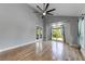 Bedroom with vaulted ceiling, hardwood floors, and large windows showcasing the outdoor landscape at 1762 Green Rd, Buford, GA 30518