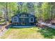 Striking home with large windows, a sprawling lawn, and a wooded backdrop at 1762 Green Rd, Buford, GA 30518
