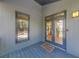 Inviting covered front porch with double glass doors and 