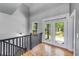 Hallway with wood floors leading to the back deck through glass doors at 1762 Green Rd, Buford, GA 30518