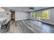Open-concept living room with stylish flooring, ceiling fan, and French doors to the backyard at 1762 Green Rd, Buford, GA 30518