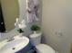 Charming powder room features a pedestal sink, decorative mirror, and modern toilet at 1835 Morning Star Ln, Tucker, GA 30084