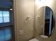 Bathroom features a round mirror, chrome towel bar, and white walls at 1835 Morning Star Ln, Tucker, GA 30084