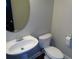 Bathroom features a white toilet, pedestal sink, oval mirror, and chrome hardware at 1835 Morning Star Ln, Tucker, GA 30084
