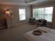 Open bedroom bathed in light with plush carpeting, dresser and sitting area at 1835 Morning Star Ln, Tucker, GA 30084
