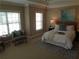 Comfortable bedroom with large windows and a sitting area at 1835 Morning Star Ln, Tucker, GA 30084