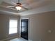 Bedroom with a ceiling fan, base trim, and black double doors at 1835 Morning Star Ln, Tucker, GA 30084