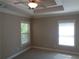 Bright bedroom with neutral carpeting, blinds, and natural light from windows at 1835 Morning Star Ln, Tucker, GA 30084