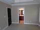 Neutral Primary bedroom with recessed lighting, ensuite bathroom, and door to private area at 1835 Morning Star Ln, Tucker, GA 30084