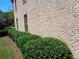 Side view of brick home featuring a lush, green hedge at 1835 Morning Star Ln, Tucker, GA 30084