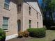 Side view of a brick house showing multiple windows and landscaped garden at 1835 Morning Star Ln, Tucker, GA 30084