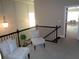 Bright hallway features decorative trim and railing, along with comfortable seating at 1835 Morning Star Ln, Tucker, GA 30084