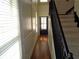 Bright hallway featuring hardwood floors, staircase, and natural light from a large window at 1835 Morning Star Ln, Tucker, GA 30084
