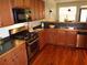 Well-equipped kitchen boasts wood cabinets, stainless steel appliances, and hardwood flooring at 1835 Morning Star Ln, Tucker, GA 30084