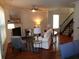 Cozy living room features fireplace, hardwood floors, ceiling fan, and an elegant staircase at 1835 Morning Star Ln, Tucker, GA 30084