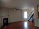 Living room with hardwood floors, fireplace, staircase, and decorative trim at 1835 Morning Star Ln, Tucker, GA 30084