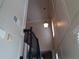 Staircase with paneled walls and high ceilings with a decorative light fixture at 1835 Morning Star Ln, Tucker, GA 30084