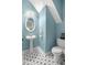 Powder room featuring an elegant pedestal sink, stylish patterned tile, and neutral blue paint at 2840 Smith Ridge Trce, Peachtree Corners, GA 30071
