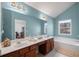 Bright bathroom features double vanity, soaking tub, and neutral tile floors at 2840 Smith Ridge Trce, Peachtree Corners, GA 30071
