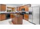Well-equipped kitchen features an island, stainless steel refrigerator, and granite countertops at 2840 Smith Ridge Trce, Peachtree Corners, GA 30071
