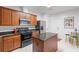 Bright kitchen with an island, stainless steel refrigerator, and ample cabinet space at 2840 Smith Ridge Trce, Peachtree Corners, GA 30071
